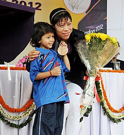 A young athlete after felicitating Mary Kom—a 2012 London Summer Olympics boxing medal winner—New Delhi, 16 August 2012